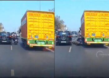 वायरल वीडियो: लापरवाह! एक बाइक पर तीन युवा ट्रक और एसयूवी के बीच से आगे निकलने की कोशिश करते हैं, पहिया के नीचे बहते हैं, जांचें कि क्या होता है